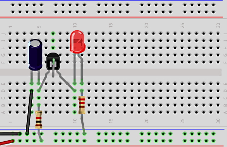یک ترانزیستور، خازن، LED و مقاومت روی یک برد الکترونیکی