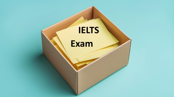 تصویر جعبه‌ای که درون آن چند کاغذ رنگی است و روی آن نوشته شده IELTS Exam