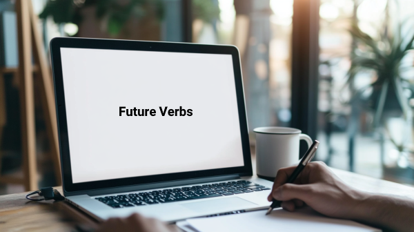 تصویر دستی در حال نوشتن در دفتر و لپ‌تاپی جلویش که نوشته Future Verbs