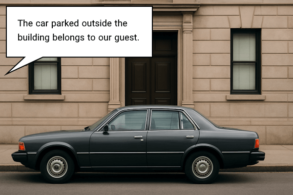 تصویری که خودرویی را در کنار یک ساختمان نشان می دهد و توصیف می کند که چگونه باید موقعیت آن را با جمله واره وصفی توضیح دهیم